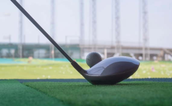Golf club and ball in driving range